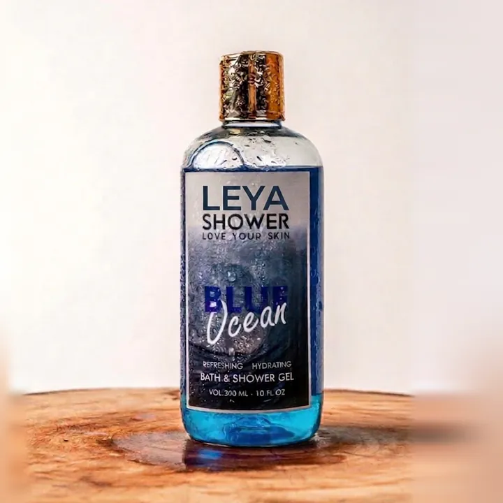 Léya Shower Blue Ocean Bath and Shower Gel bottle on a wooden slab